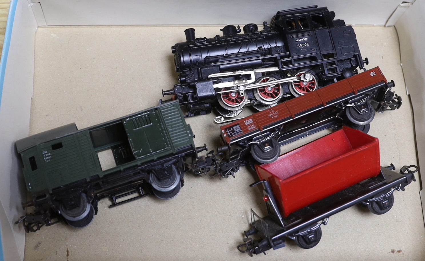 A German Marklin 7390 miniature rail station, tracking, engine and carriages, with original booklet